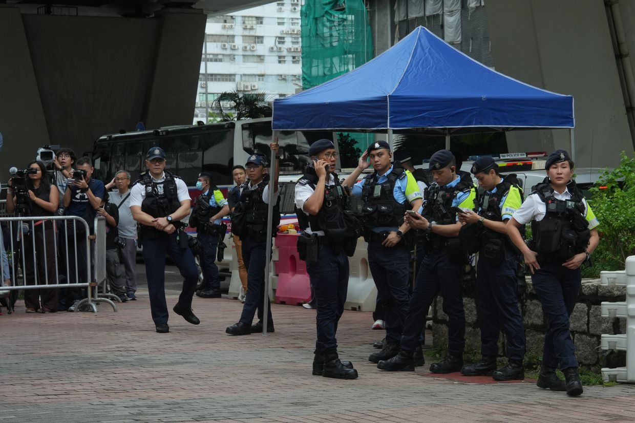 Hong Kong arrests woman over seditious T-shirt as democracy advocates face conviction